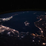 The Mediterranean Sea ringed by coastal city lights