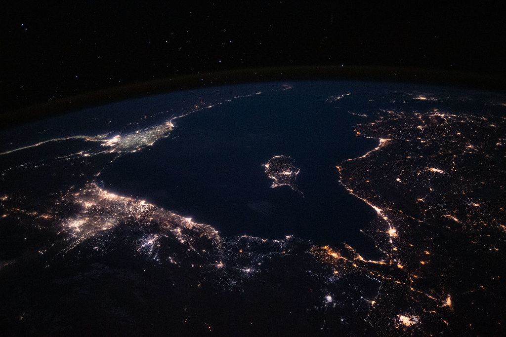 The Mediterranean Sea ringed by coastal city lights