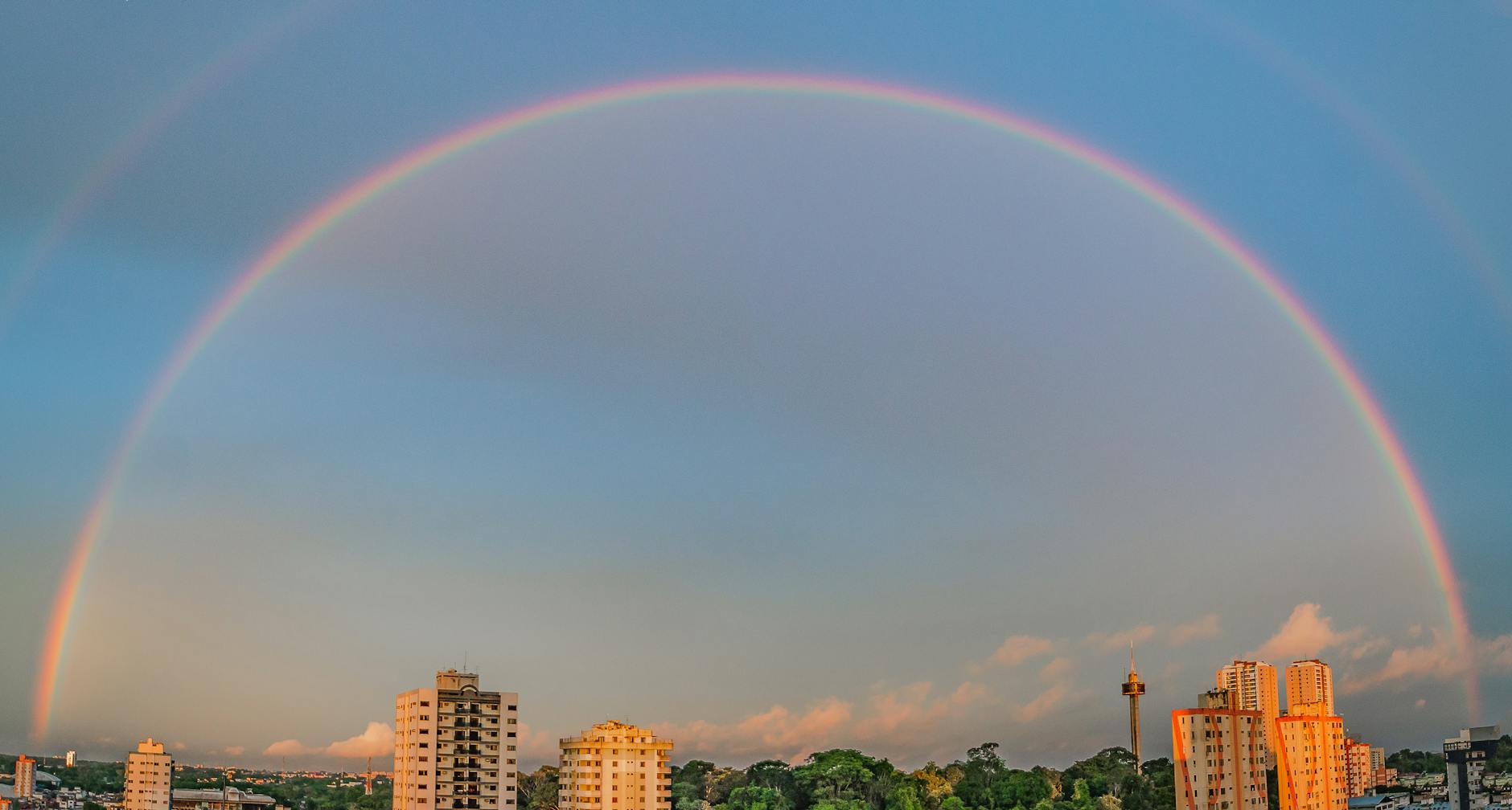 rainbow over high rise buildings